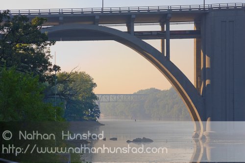 The Franklin Avenue Bridge over the Mississippi River, with the rail crossing in the background.